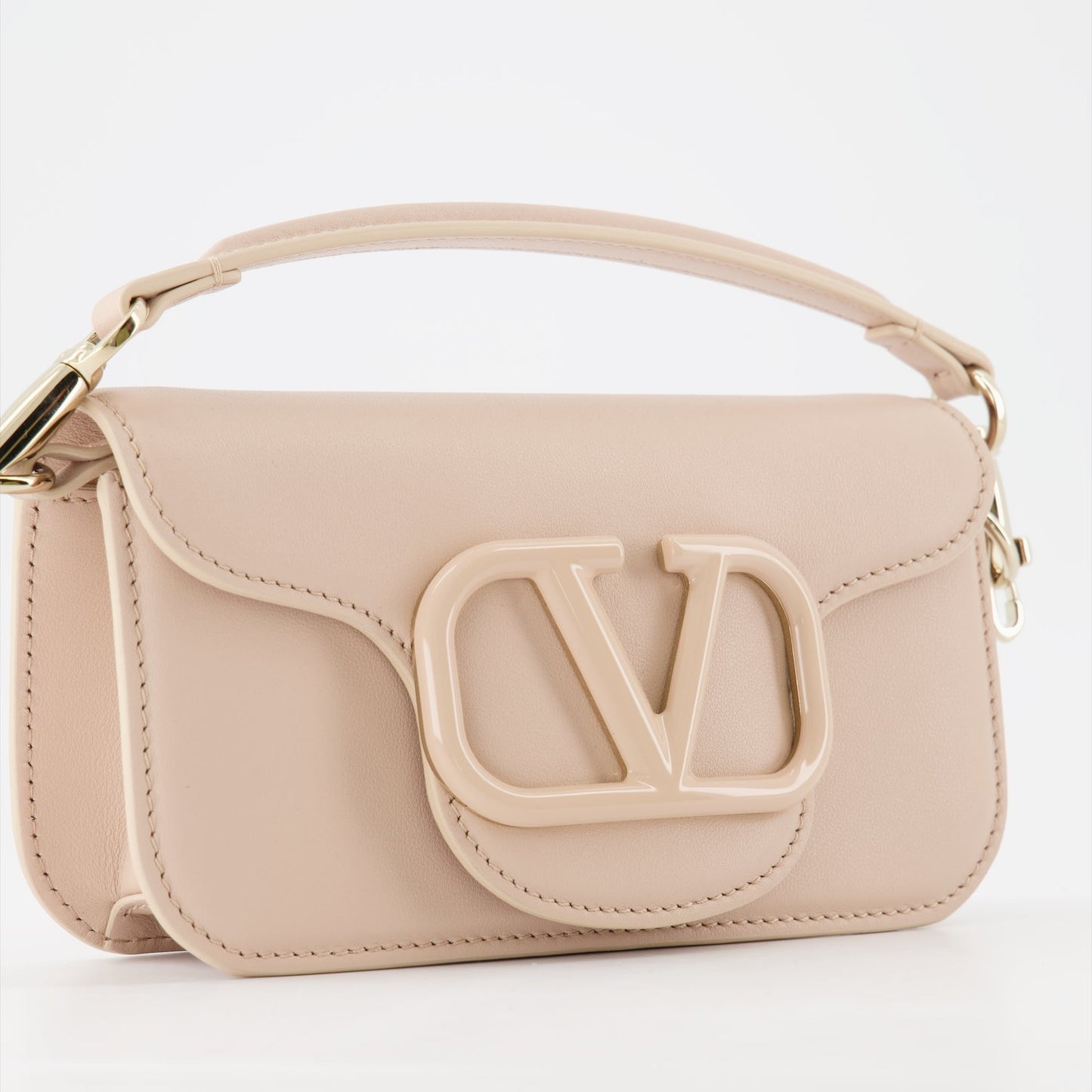 beige handbag, luxury bag, Valentino Garavani, designer accessory, elegant handbag