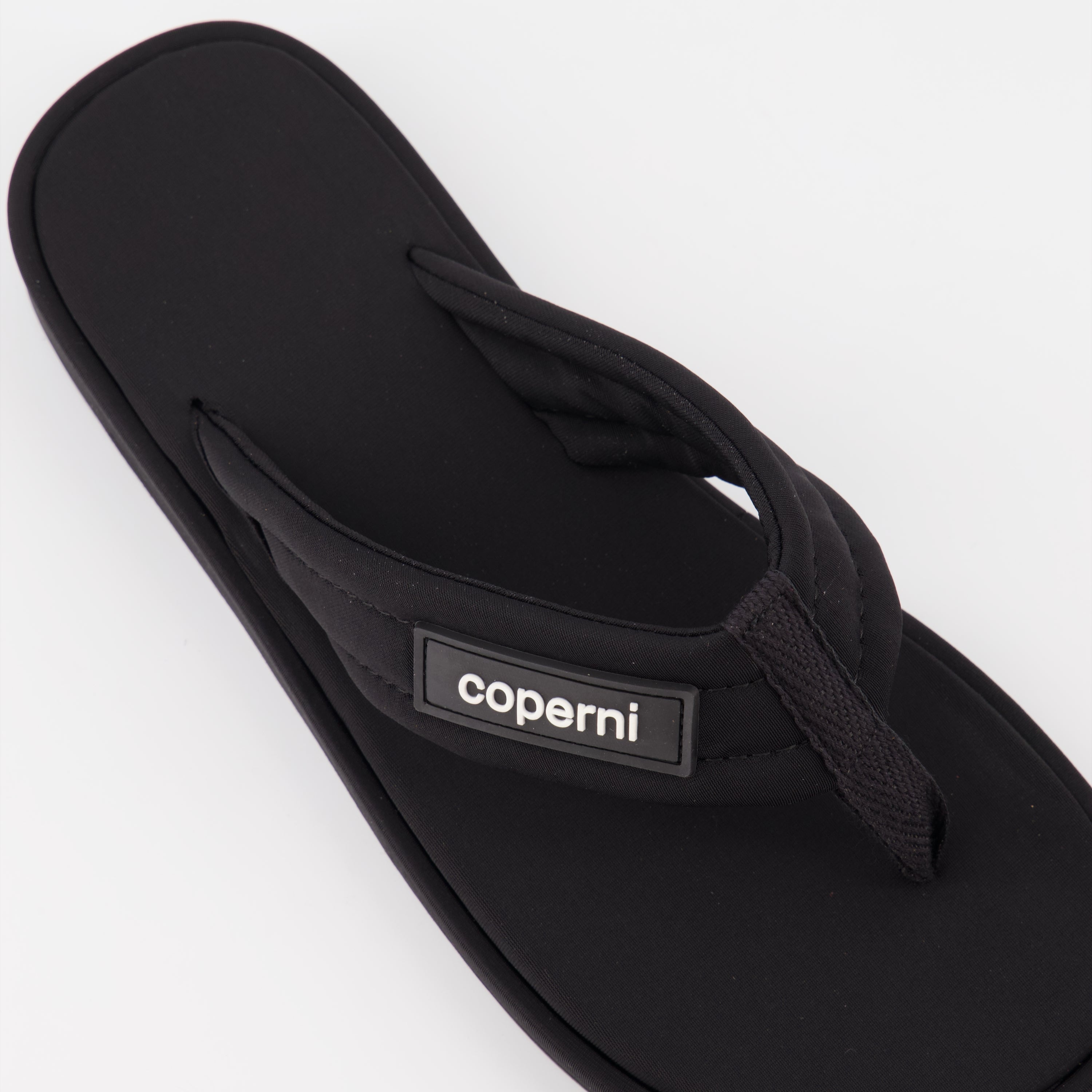 Coperni flip-flops, black logo sandals, luxury beachwear, stylish summer footwear, premium casual sandals